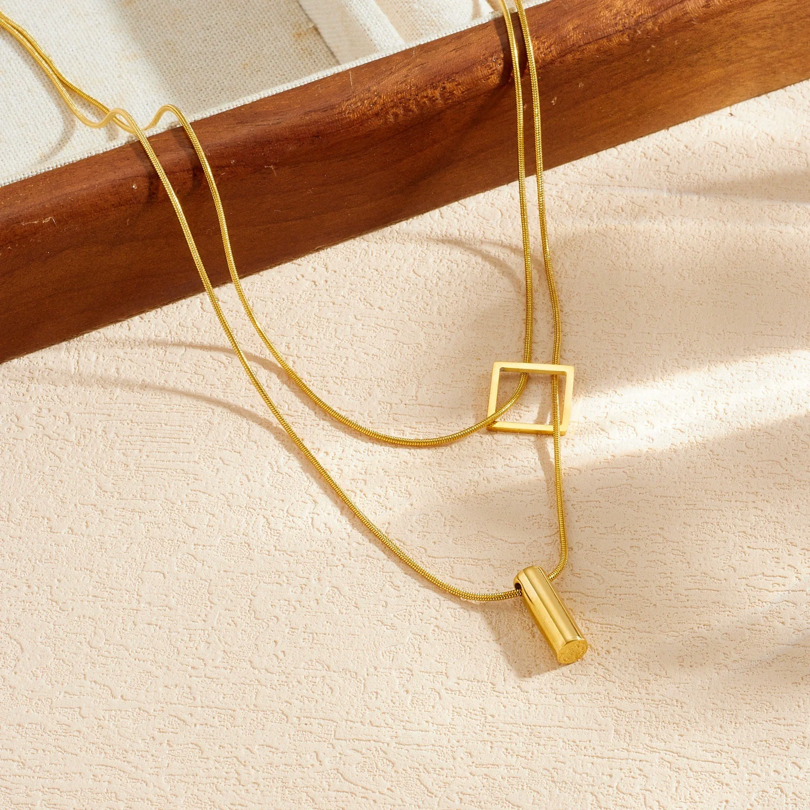 Wholesale Women's Light Luxury Goldplated Stainless Steel Geometric Snake Bone Chain Necklace With Square And Cylindrical Pendant - Image 3